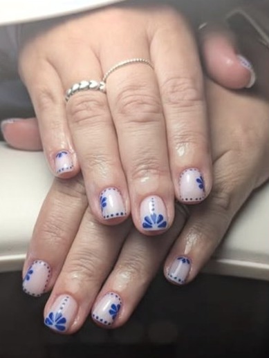 Pale nails with blue dotted floral designs