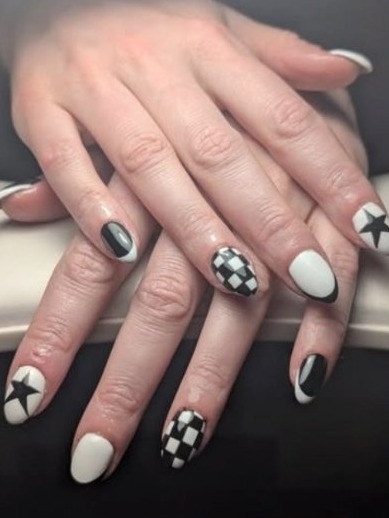 Black and white nails with checkerboard and star designs